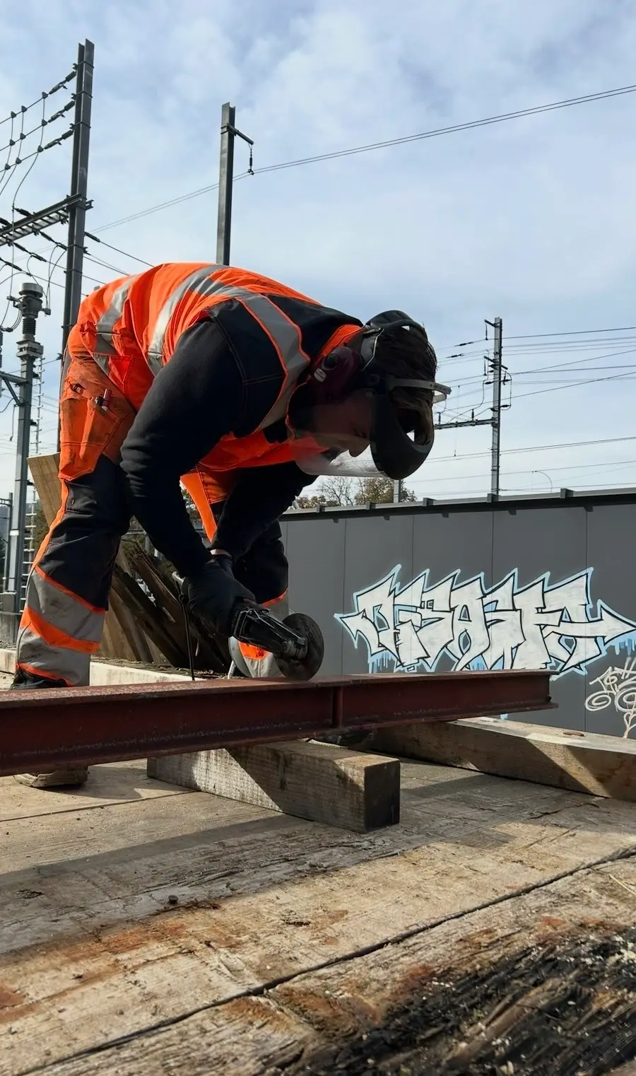 A cut with the angle grinder on a wagon, sparks over the track.